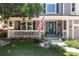 Inviting front porch with a charming American flag, decorative flower pots, and seating area at 1774 Spring Water Pl, Highlands Ranch, CO 80129