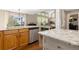Bright kitchen and breakfast nook with stainless steel appliances, granite countertops and view to the living room at 1774 Spring Water Pl, Highlands Ranch, CO 80129