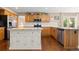 Spacious kitchen featuring wooden cabinets, stainless steel appliances, and a center island at 1774 Spring Water Pl, Highlands Ranch, CO 80129