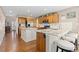Open kitchen with hardwood floors, dual islands with countertops, and wooden cabinetry at 1774 Spring Water Pl, Highlands Ranch, CO 80129