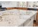 Modern kitchen with granite countertops, stainless steel appliances, and custom wood cabinets at 1774 Spring Water Pl, Highlands Ranch, CO 80129