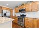 Well-equipped kitchen featuring stainless steel appliances, granite countertops, and ample wooden cabinetry at 1774 Spring Water Pl, Highlands Ranch, CO 80129