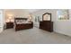 Carpeted main bedroom featuring a large window and dark wood bedroom set with nightstands at 1774 Spring Water Pl, Highlands Ranch, CO 80129
