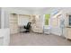 Bright office with built-in shelving, a white desk, and a comfortable armchair by the window at 1774 Spring Water Pl, Highlands Ranch, CO 80129