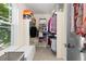 Well-organized walk-in closet with built-in shelving and storage, and natural light from the window at 1774 Spring Water Pl, Highlands Ranch, CO 80129