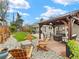 Landscaped backyard with a pergola, seating area, and a well-manicured lawn at 3052 S Gilpin St, Denver, CO 80210