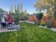 Serene backyard with manicured lawn, patio, garden, privacy fence, and lush landscaping, creating an ideal outdoor retreat at 3052 S Gilpin St, Denver, CO 80210