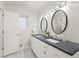 Modern bathroom featuring double sinks, sleek countertops, stylish lighting, and elegant mirrors at 3052 S Gilpin St, Denver, CO 80210