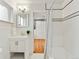Bright bathroom featuring a white vanity, stylish fixtures, and a classic white-tiled shower with black accents at 3052 S Gilpin St, Denver, CO 80210