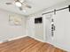 Bright bedroom boasts wood floors, closet, and bathroom access through a modern sliding door at 3052 S Gilpin St, Denver, CO 80210