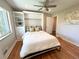 Cozy bedroom with a Murphy bed, built-in shelving, and hardwood floors for added convenience at 3052 S Gilpin St, Denver, CO 80210