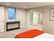 Spacious carpeted bedroom with a vibrant orange blanket, natural light, and ample closet space at 3052 S Gilpin St, Denver, CO 80210