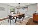 Elegant dining room features a modern light fixture and ample natural light at 3052 S Gilpin St, Denver, CO 80210