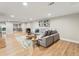 Spacious living room with plush seating, modern decor, wood-look flooring, and a large mirror reflecting the bright space at 3052 S Gilpin St, Denver, CO 80210