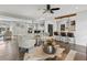Open-concept living room and kitchen area featuring hardwood floors, stylish furniture, and modern decor at 3052 S Gilpin St, Denver, CO 80210