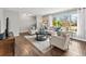 Living room featuring a neutral color palette, hardwood flooring and bright sunlight at 3052 S Gilpin St, Denver, CO 80210