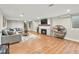 Basement living room features a fireplace, mounted TV, and staircase to the upper level at 3052 S Gilpin St, Denver, CO 80210