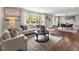 Bright and airy living room featuring modern furniture, hardwood floors, and large windows at 3052 S Gilpin St, Denver, CO 80210