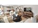 Open-concept living space featuring a dining area, living room, and hardwood flooring throughout at 3052 S Gilpin St, Denver, CO 80210