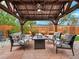 Cozy pergola with comfortable seating and a fire pit in a landscaped backyard at 3052 S Gilpin St, Denver, CO 80210
