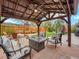 Backyard featuring a shaded pergola seating area, a fire pit, and an outdoor gathering space at 3052 S Gilpin St, Denver, CO 80210