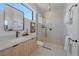 Modern bathroom with a walk-in shower, floating vanity, and stylish fixtures at 5088 E Donald Ave, Denver, CO 80222