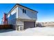 Two-story home featuring vinyl siding and attached two-car garage, in a residential neighborhood at 46533 Avery Ln, Bennett, CO 80022