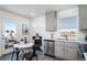Compact eat in kitchen with stainless appliances, lots of natural light, and an attached dining area at 46533 Avery Ln, Bennett, CO 80022