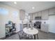 Modern kitchen with stainless steel appliances, light gray cabinets, and an adjacent dining area at 46533 Avery Ln, Bennett, CO 80022