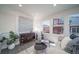 Stylish living room featuring modern furniture, large windows, and ample natural light at 46533 Avery Ln, Bennett, CO 80022