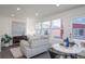 Bright living room with stylish decor, comfortable seating, and ample natural light at 46533 Avery Ln, Bennett, CO 80022