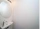 Modern powder room features a sleek vessel sink, contemporary faucet, and stylish round mirror at 46533 Avery Ln, Bennett, CO 80022