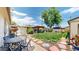 Well-maintained backyard featuring a lush lawn, garden, gazebo, and outdoor seating area at 1741 W 55Th Pl, Denver, CO 80221