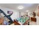 Spacious basement with foosball table, gym equipment, and relaxing couches at 1741 W 55Th Pl, Denver, CO 80221