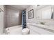 Bright bathroom featuring gray tiled shower with tub and a marble countertop at 1741 W 55Th Pl, Denver, CO 80221