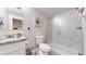 Modern bathroom featuring a glass-enclosed shower, vanity with stylish countertop, and toilet at 1741 W 55Th Pl, Denver, CO 80221