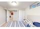 Cozy bedroom with comfortable bed and natural light coming through basement windows at 1741 W 55Th Pl, Denver, CO 80221