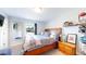 Spacious bedroom with a large window and a wooden frame bed at 1741 W 55Th Pl, Denver, CO 80221