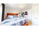 Bedroom with a wooden frame bed, adjacent to walk-in closet at 1741 W 55Th Pl, Denver, CO 80221