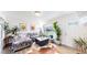 Bright living room featuring hardwood floors, a large window, and contemporary furnishings at 1741 W 55Th Pl, Denver, CO 80221
