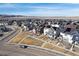 A high-angle shot shows a vast residential neighborhood of detached homes, many with solar panels and mountain views at 8211 Monte Vista Cir, Littleton, CO 80125