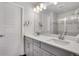Bathroom featuring double sinks, modern vanity, and a large framed mirror at 8211 Monte Vista Cir, Littleton, CO 80125