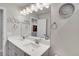 Well-lit bathroom with double sinks, modern fixtures, and decorative wall accents at 8211 Monte Vista Cir, Littleton, CO 80125