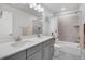 Contemporary bathroom with double sink vanity, large mirror, and tiled shower/tub combination at 8211 Monte Vista Cir, Littleton, CO 80125