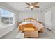 Bedroom featuring a bright window view, ceiling fan, and sliding closet door at 8211 Monte Vista Cir, Littleton, CO 80125