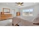 Bedroom featuring a bright window view and multiple wood dressers at 8211 Monte Vista Cir, Littleton, CO 80125