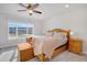 Bedroom featuring a bright window view, ceiling fan, and matching wood nightstands at 8211 Monte Vista Cir, Littleton, CO 80125