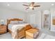 Bedroom featuring a bright window view, ceiling fan, and hallway access at 8211 Monte Vista Cir, Littleton, CO 80125