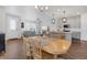 Bright dining area featuring an open-concept design, hardwood floors, and modern lighting at 8211 Monte Vista Cir, Littleton, CO 80125