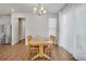 Dining room area showcasing a wooden table with seating, stainless steel fridge, and access to a staircase at 8211 Monte Vista Cir, Littleton, CO 80125